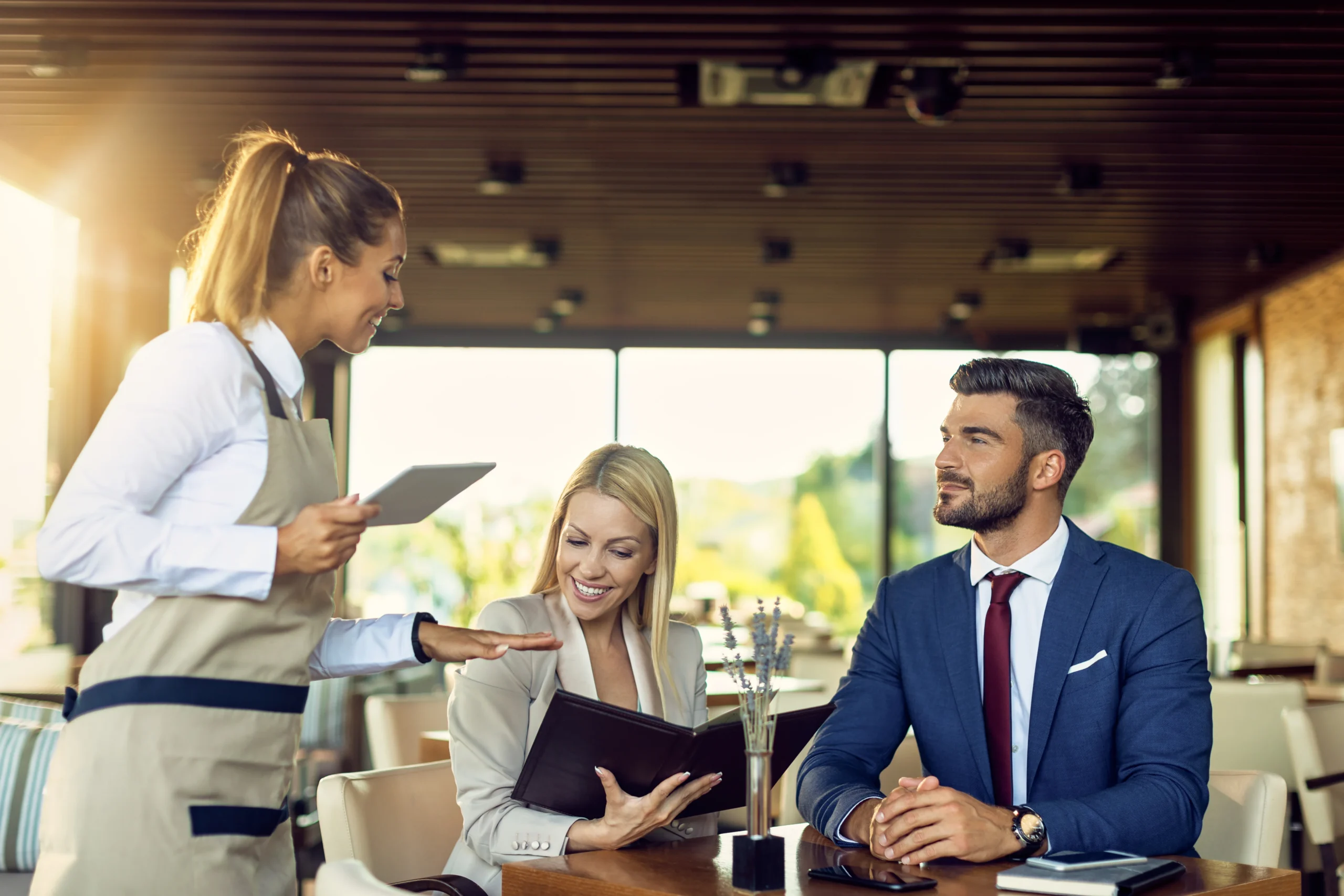 Business Couple Talking Waitress While Choosing Order From Menu Restaurant